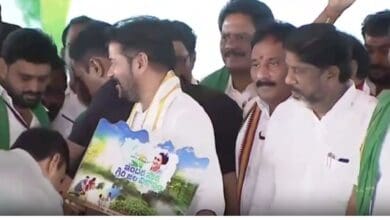 The image shows principal secretary of tribal welfare department A Sharath trying to touch the feet of chief minister A Revanth Reddy during an official programme held at Macharam village in Nagarkurnool district on Monday, May 19.