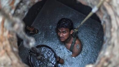 the image displays a picture of manual scavenger worker