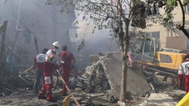 The image of rescue workers from the Iranian Red Crescent Society clear rubble and debris at the site of an explosion in Tehran following an Israeli strike on June 13, 2025.