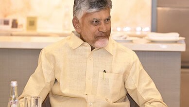 Andhra Pradesh Chief Minister N Chandrababu Naidu seated at a table during his UAE visit.