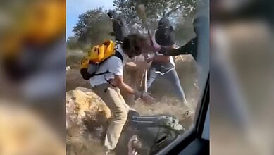 Masked settlers assault Palestinian farmers and activists during the olive harvest in Turmus Ayya, West Bank, October 19.