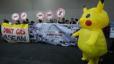 Activists, and one dressed in a Pikachu costume, protest Japan's financing of coal and natural gas projects during the COP30 U.N. Climate Summit, Friday, Nov. 14, 2025, in Belem, Brazil. (AP Photo)