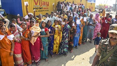 Voters wait in a queue to cast votes at a polling station during the first phase of the Bihar Assembly elections at Bakhtiarpur in Patna on Thursday. (PTI Photo)