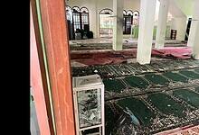 Interior of a mosque in Jakarta showing shattered glass, debris, and damaged prayer mats after explosions during Friday prayers.