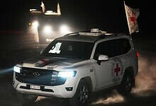 Red Cross convoy drives through Gaza at night carrying the bodies of three hostages for transfer to Israel.