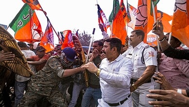Security personnel try to stop BJP supporters during a protest against the alleged killing of a Hindu youth in Bangladesh, near Howrah Bridge, Wednesday, Dec. 24, 2025. (PTI Photo)