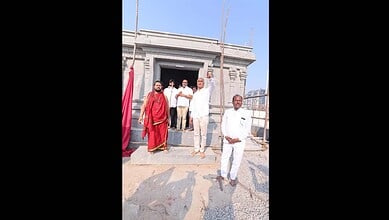 Temple construction site with officials and workers in Telangana.
