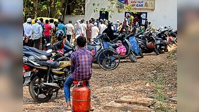 People waiting in line for LPG cylinders during fuel shortage.