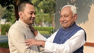 Bihar politicians engaging in a friendly outdoor discussion, reflecting political developments.