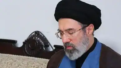 Mojtaba Khamenei wearing black turban and glasses.
