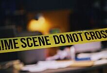 Crime scene photo showing police tape at a construction site in Hyderabad after a double murder.