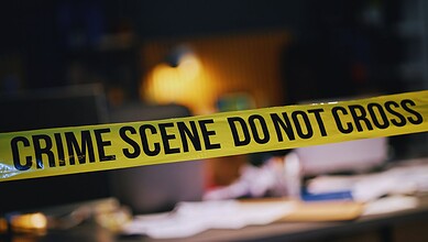 Crime scene photo showing police tape at a construction site in Hyderabad after a double murder.