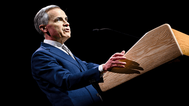 Canadian Prime Minister Carney speaking at a podium during a political event.