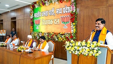 Man speaking at a panel discussion on UCC draft bill with MPs and officials present.