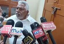 Revanth Reddy surrounded by media microphones during Telangana Congress controversy.