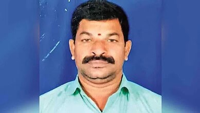 Man in green shirt with mustache and bindi, portrait photo for The Siasat Daily.