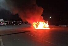 Explosion on the road with fire and smoke at night.