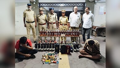 Illegal liquor bust in Hyderabad with police officers and seized bottles displayed.