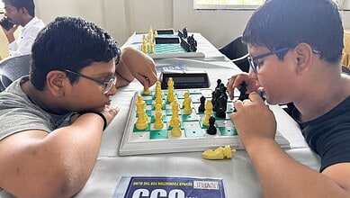 Two blind chess players competing in a game, focusing intensely on the board in Hyderabad.