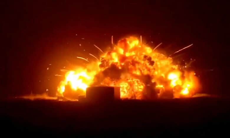 Explosion at night with bright flames and smoke, creating a dramatic scene with fiery destruction and int.