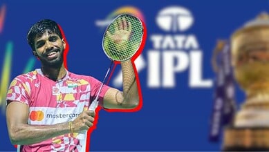 A young cricket player celebrating with a bat in front of the Tata IPL logo during a match.