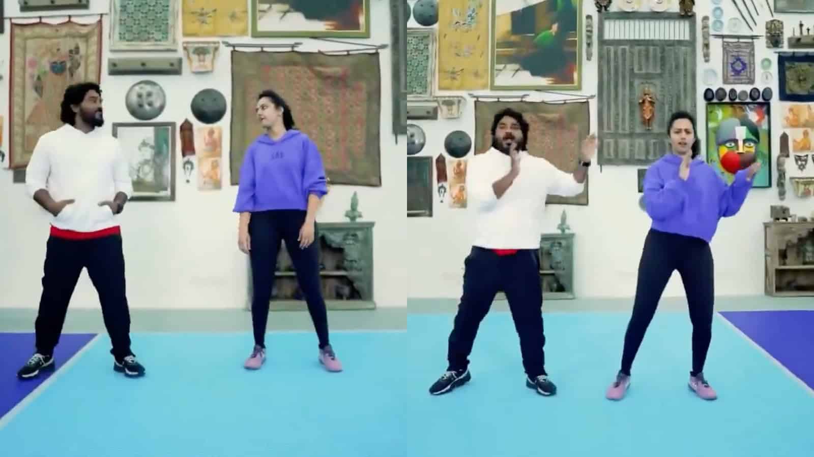 Four dancers performing in an art gallery with various paintings and artworks on the wall behind them.