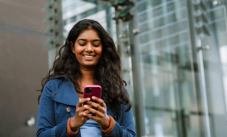 An Indian woman using a mobile phone used for representational purposes