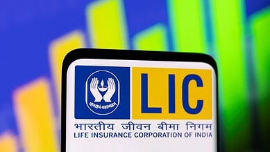 LIC logo displayed on a digital screen with colourful financial graphs in the background.