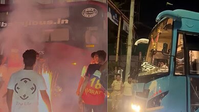 Bus fire emergency in India with flames and smoke, rescue efforts ongoing at night.