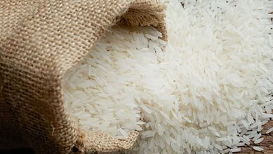 Rice grains spilling from a burlap sack, close-up shot.