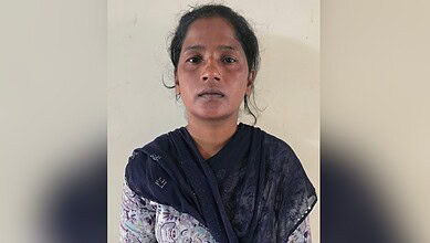 Empowered woman in traditional attire looking directly at the camera, symbolising strength and resilience.