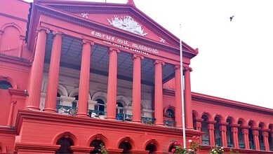 Karnataka High Court building with red facade and classical columns in Bangalore.