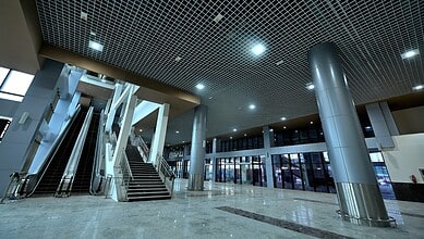 Modern interior of Secunderabad Railway Station with escalators and spacious waiting area.