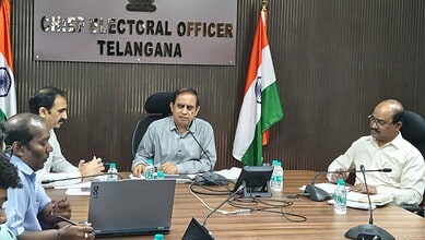 Telangana Chief Electoral Officer chairs a meeting with officials in a conference room.