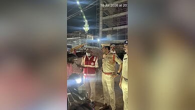 Police officers inspecting a motorcycle at night during a crackdown in Cyberabad.