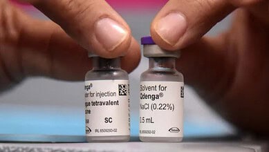Vials of Takeda's Dengue Vaccine QDENGA with hands handling them.