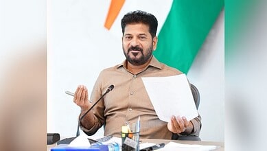 Telangana official holding a document during a press conference in Hyderabad.
