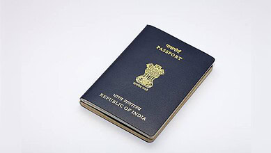 Indian passport booklet with emblem and text on cover, isolated on white background.