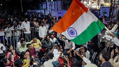 Protesters holding Indian flag during Jharkhand exam protest demonstration.