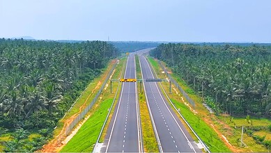 New greenfield highway connecting Telangana and Andhra Pradesh, surrounded by lush greenery.