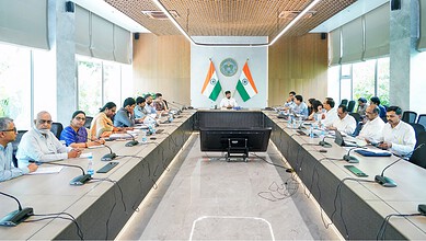 Official meeting with government officials and delegates in a modern conference room.