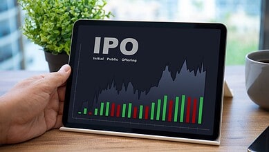 Digital tablet displaying IPO market graph with green and red bars and line chart.