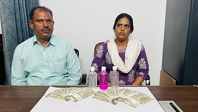 Two government officers in ACB net for accepting Rs 75K bribe, seated at a table with money and bottles.