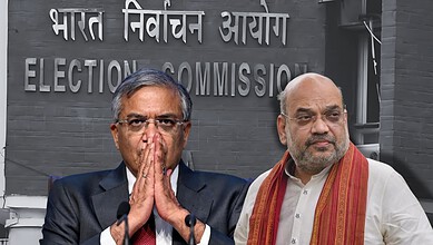 Indian Election Commission officials with leaders at a press event in front of a sign.