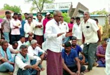 Officials convince villagers who threatened to boycott the elections, to cast their vote.