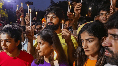 New Delhi: Wrestlers Sakshi Malik, Vinesh Phogat, Sangeeta Phogat and Bajrang Punia light candles during their protest at Jantar Mantar, in New Delhi, Sunday, May 7, 2023. (PTI Photo/Atul Yadav)