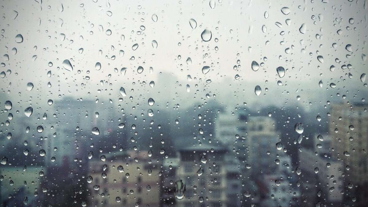 Representational image of a rain-soaked window in Hyderabad with water droplets.