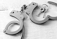Representational Image of handcuffs on the desk