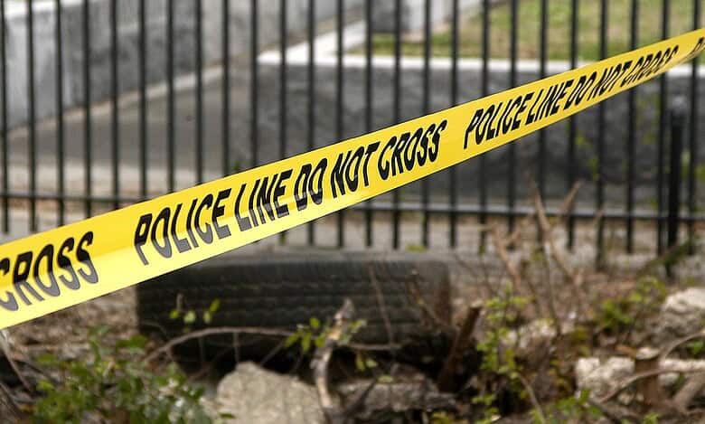 Yellow police tape reading 'Police Line Do Not Cross' at an accident scene - represents investigation into fatal hit-and-run involving Indian student in US.
