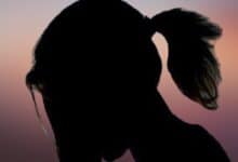 The image displays a silhouette of a girl with a reddish background